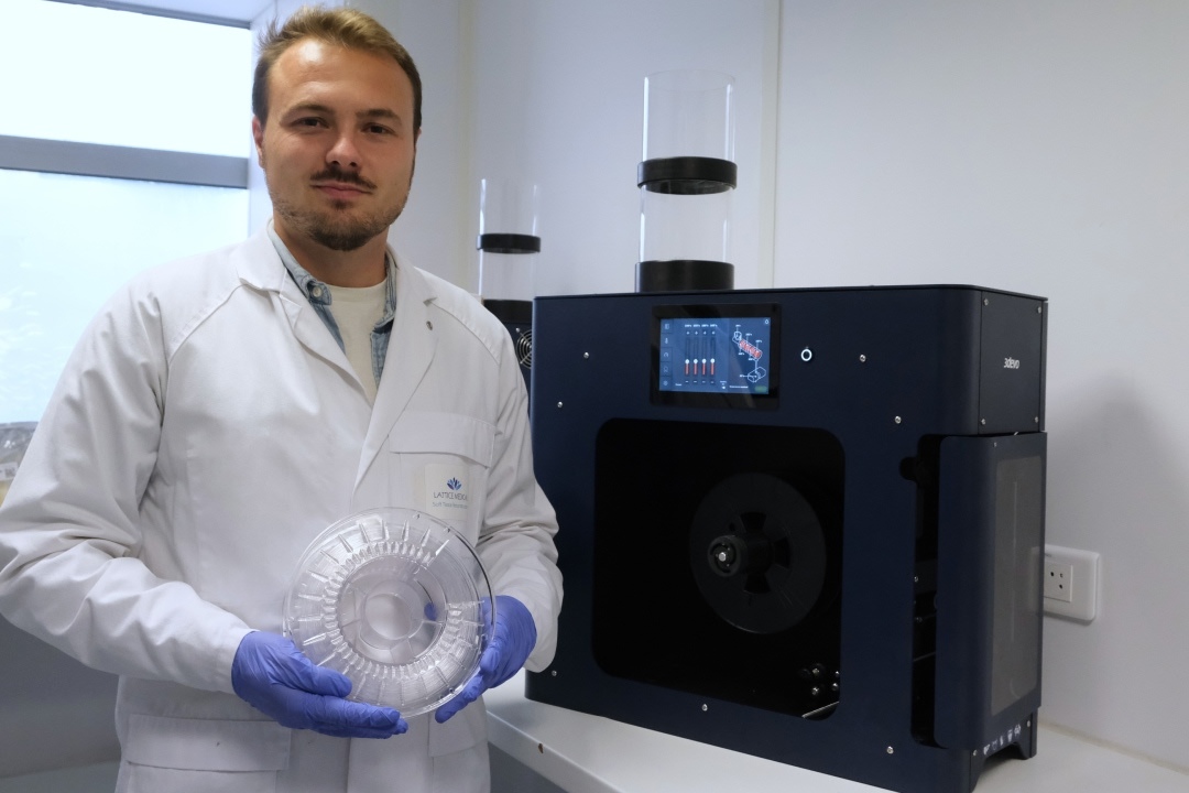 Lattice Medical researcher with printed prototype next to Filament Maker TWO