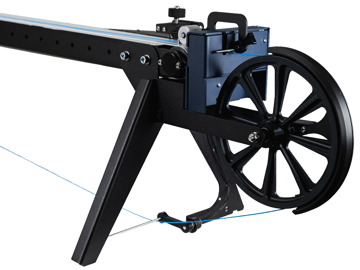 Close-up of the FMX10's winder assembly, showing the large spoked wheel, tensioning arm, and mounting frame.