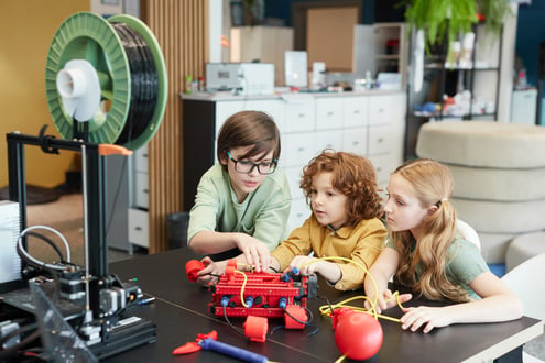 Students Inspecting 3D Printer