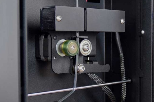PLA extrudate going through the pullers of the FM1.