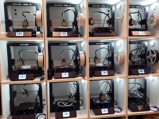 12 3D Printers on a rack.