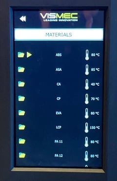 The Vismec Dryer touchscreen with the material preset settings on display, with ABS, PLA and others in a list.