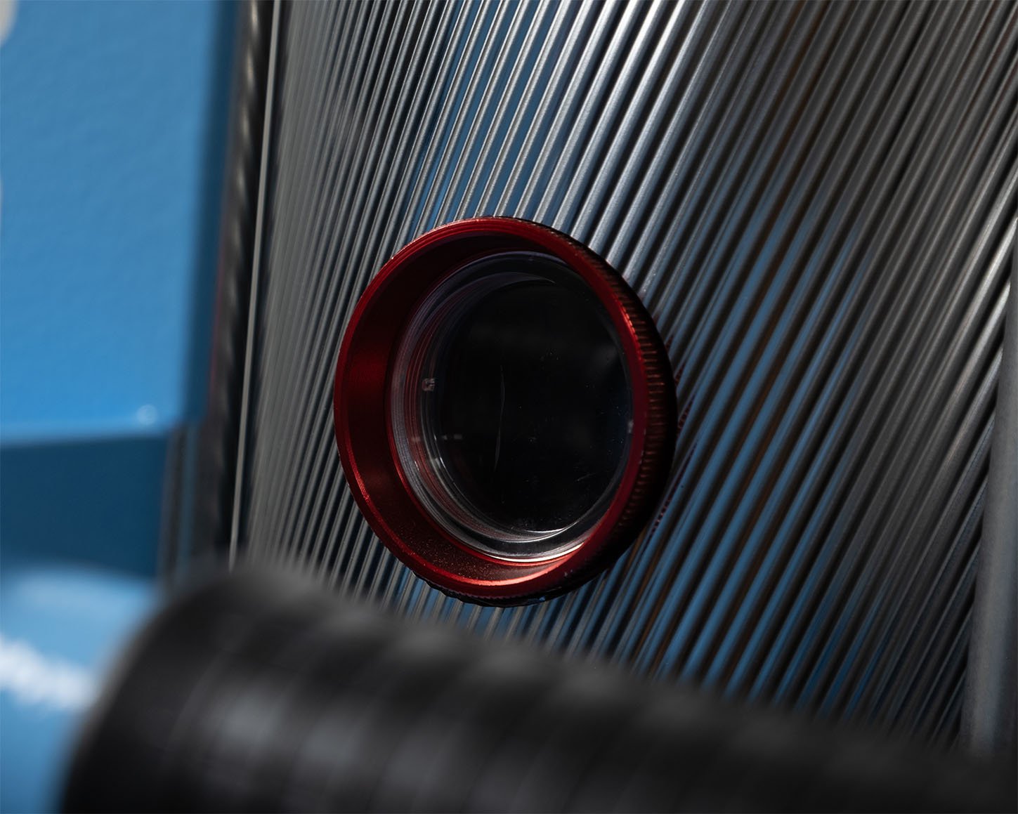 Close-up of the sight glass on the XD12 desiccant dryer's insulated OTX hopper, used to check material level during drying.